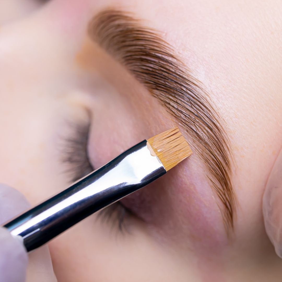 Close-up of brow lamination treatment at Rouge Ink, straightening and lifting eyebrow hairs for a fuller and well-groomed look.