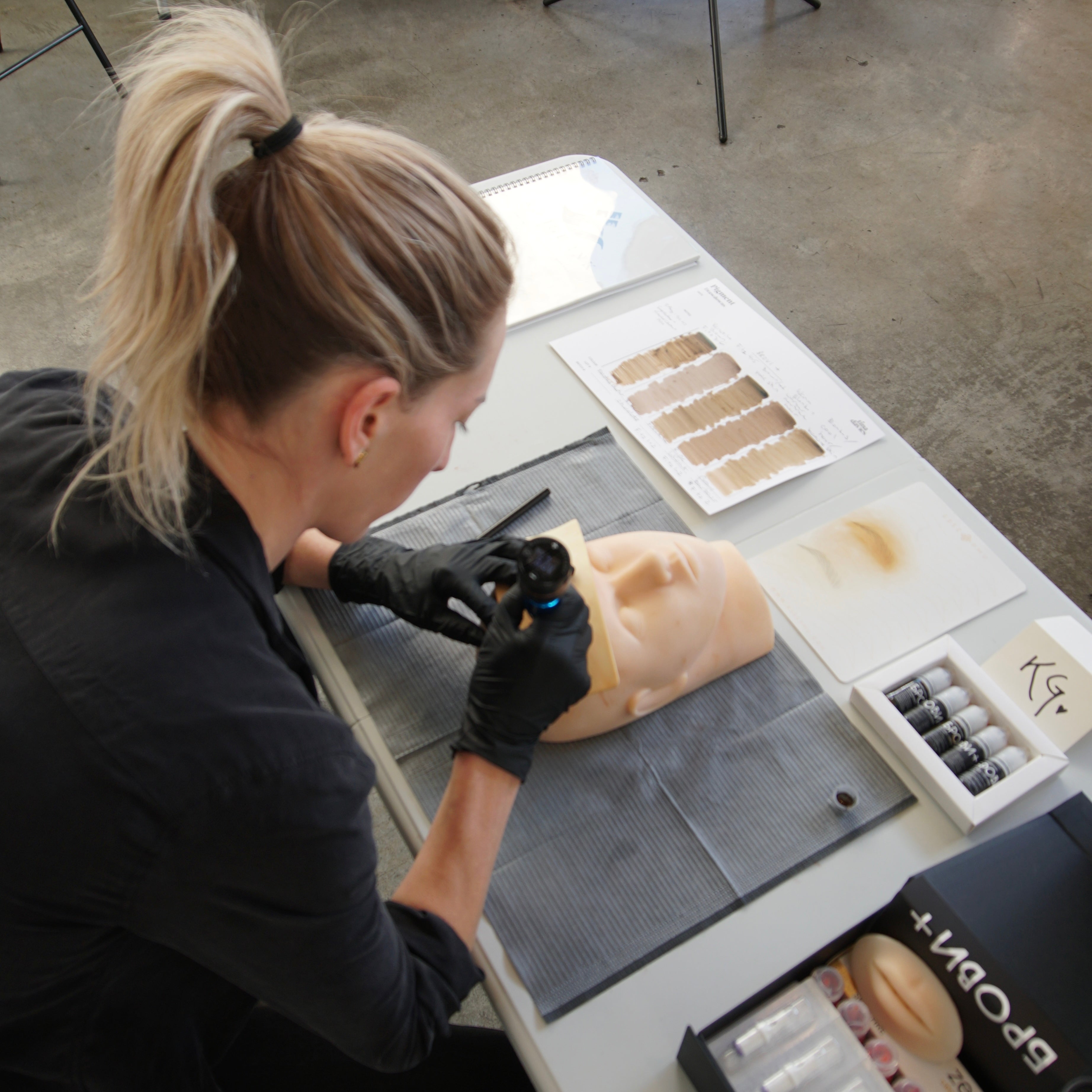 Rouge Ink student practices tattoo technique.