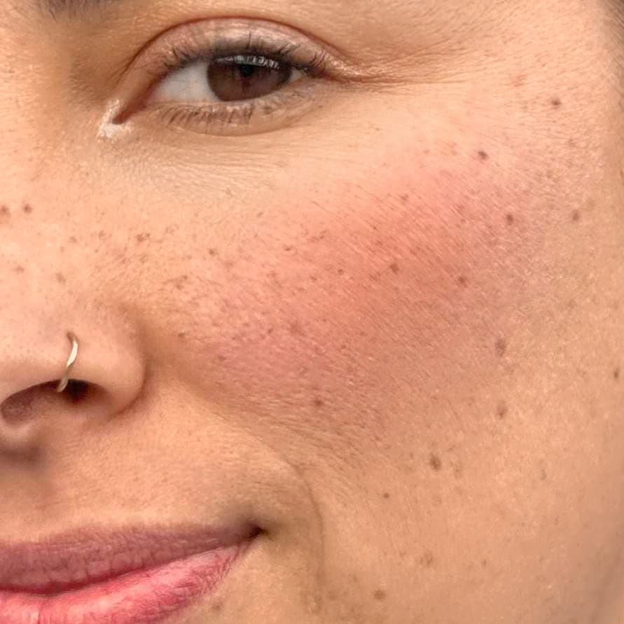 Close-up of tattooed freckles at Rouge Ink, mimicking natural freckles for a playful, subtle enhancement.