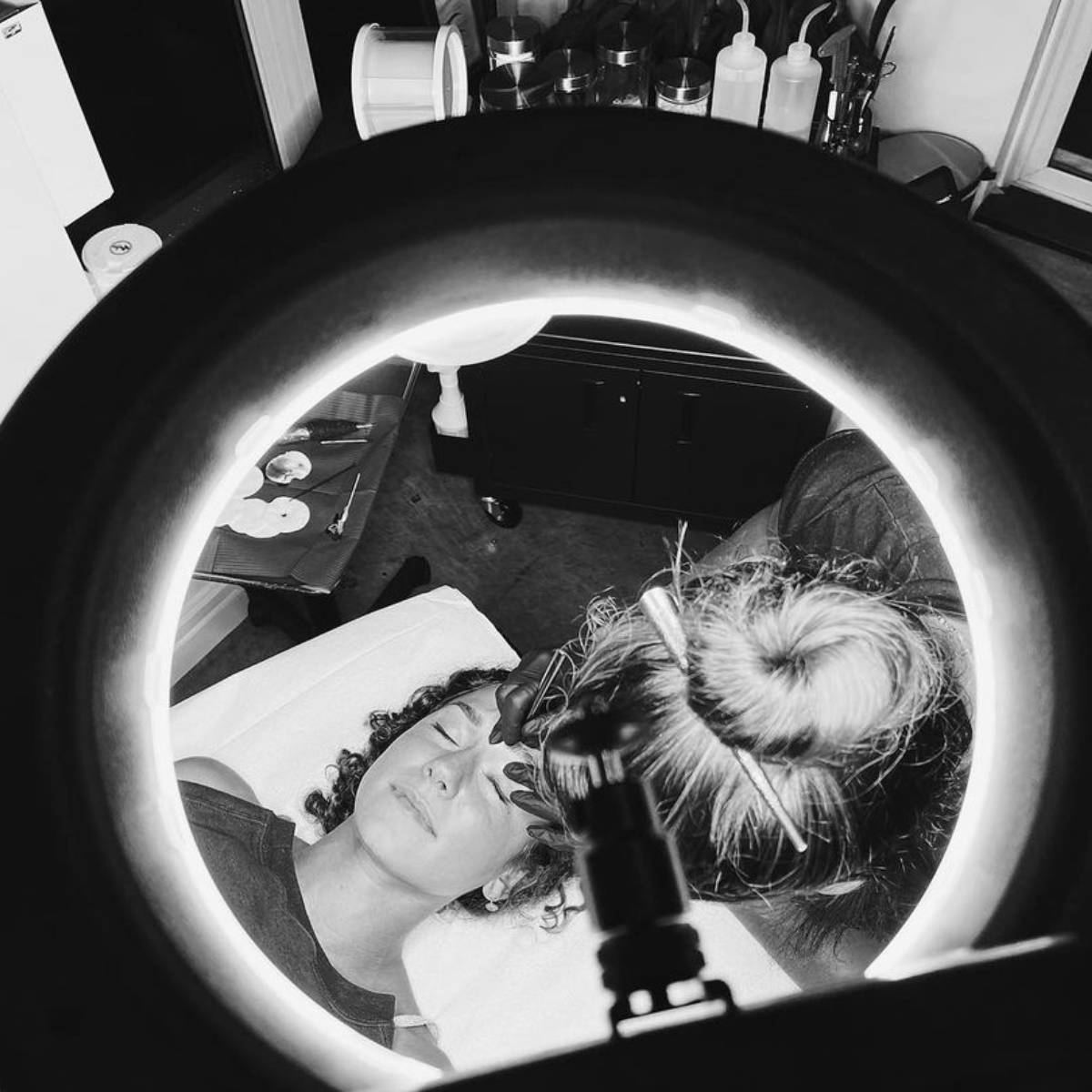 A Rouge Ink student performs a service on a client.